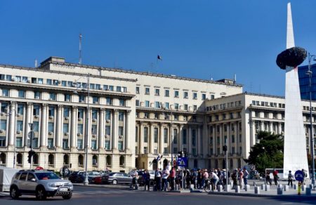 The Rebirth memorial (olive on a stick) and the Central Committee Communist Party building where Ceausescu held his final speech. Photo: Albert Ehrnrooth